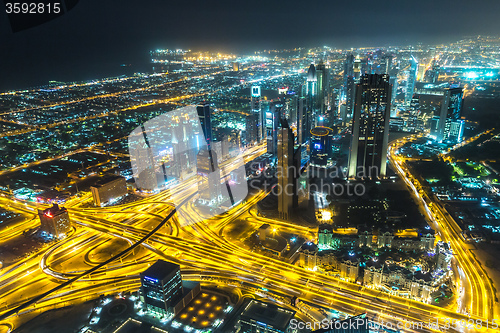 Image of Dubai downtown night scene with city lights,