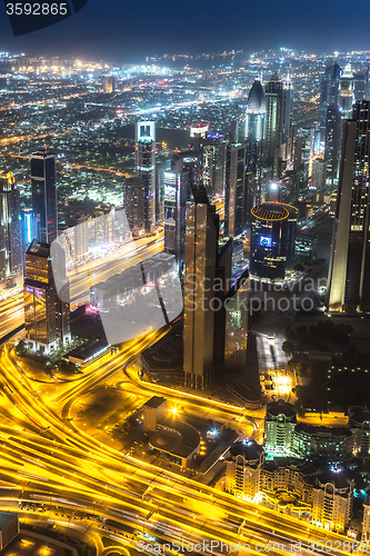 Image of Dubai downtown night scene with city lights,