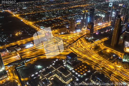 Image of Dubai downtown night scene with city lights,