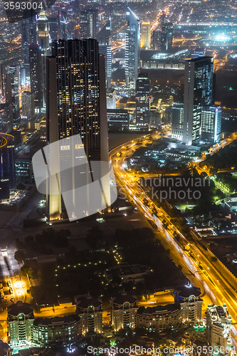 Image of Dubai downtown night scene with city lights,