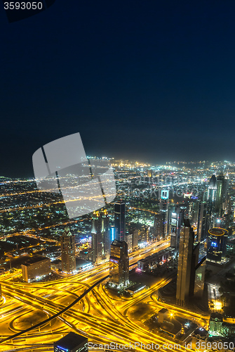 Image of Dubai downtown night scene with city lights,