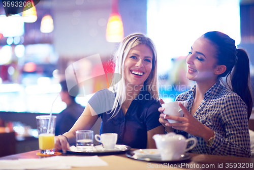 Image of girls have cup of coffee in restaurant