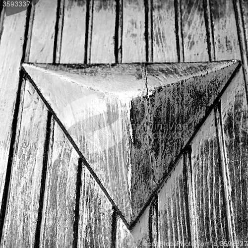 Image of grain texture of a brown antique wooden old door in italy   euro