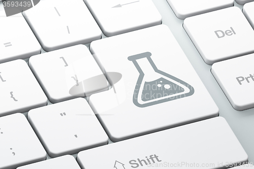 Image of Science concept: Flask on computer keyboard background
