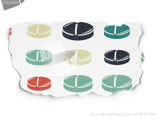 Image of Health concept: Pill icons on Torn Paper background