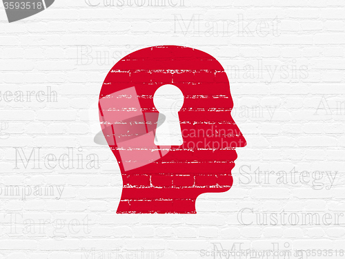 Image of Advertising concept: Head With Keyhole on wall background