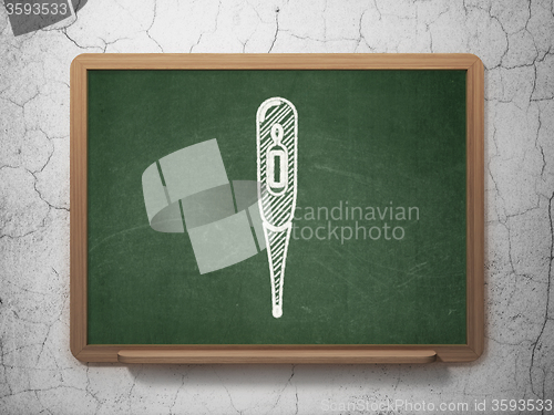 Image of Health concept: Thermometer on chalkboard background