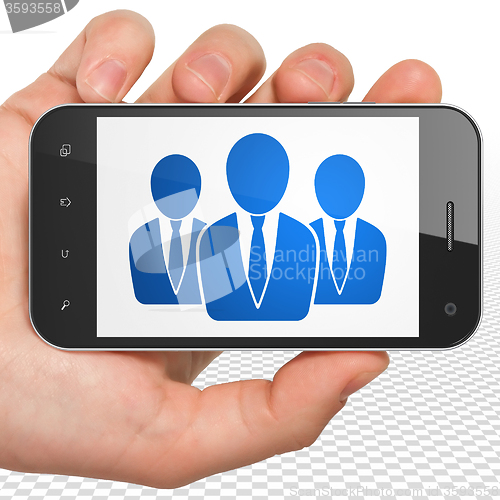 Image of News concept: Hand Holding Smartphone with Business People on display