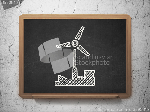 Image of Industry concept: Windmill on chalkboard background