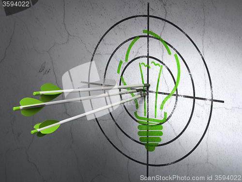 Image of Business concept: arrows in Light Bulb target on wall background