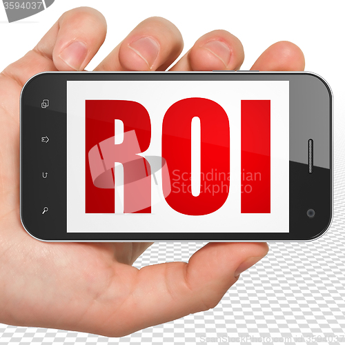 Image of Finance concept: Hand Holding Smartphone with ROI on display