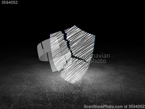 Image of Security concept: Broken Shield in grunge dark room