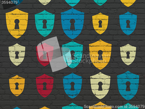 Image of Safety concept: Shield With Keyhole icons on wall background