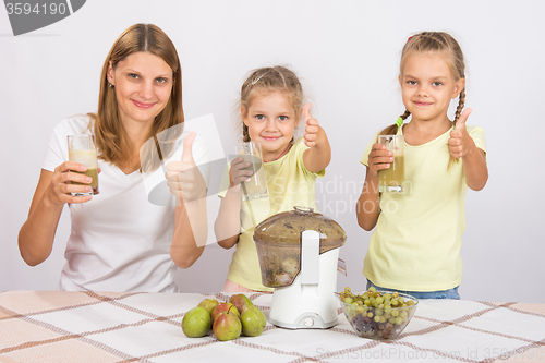 Image of Mother and two daughters show a thumbs up freshly prepared juice