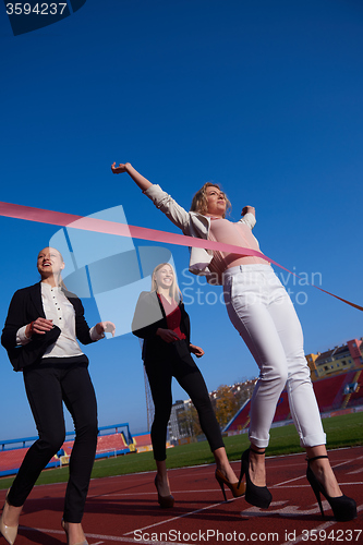 Image of business people running on racing track