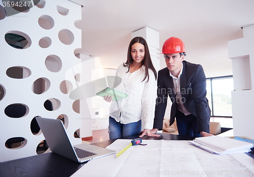 Image of couple buying new home with real estate agent