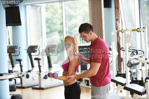 Image of young sporty woman with trainer exercise weights lifting