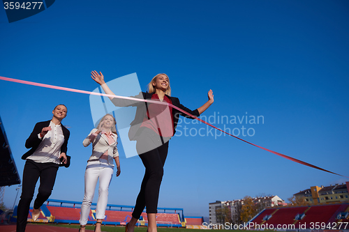 Image of business people running on racing track