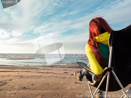 Image of woman sitting on deckchair