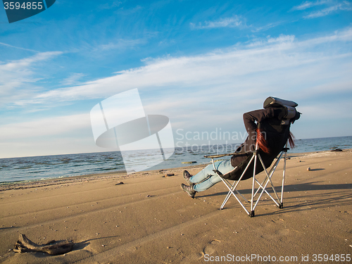 Image of woman sitting on beach