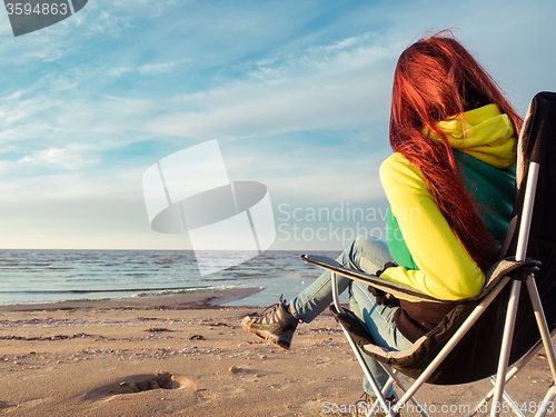 Image of woman sitting on deckchair