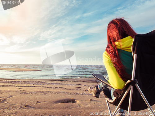 Image of woman resting on beach