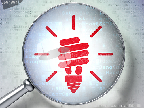 Image of Business concept: Energy Saving Lamp with optical glass on digital background