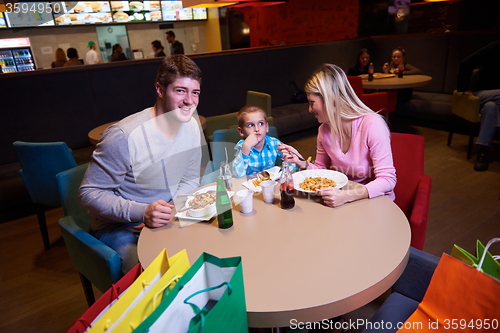 Image of family having lunch in shopping mall