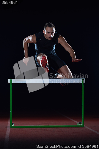 Image of athlete jumping over a hurdles