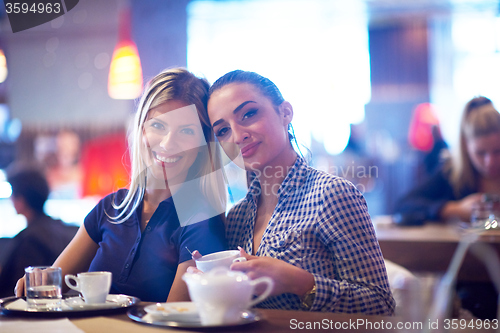 Image of girls have cup of coffee in restaurant