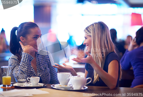 Image of girls have cup of coffee in restaurant