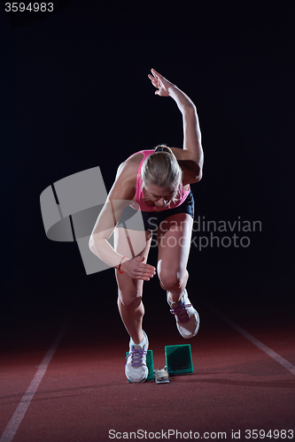 Image of pixelated design of woman  sprinter leaving starting blocks