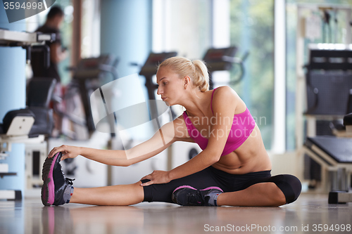 Image of woman stretching and warming up for her training at a gym