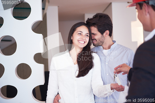 Image of couple buying new home with real estate agent