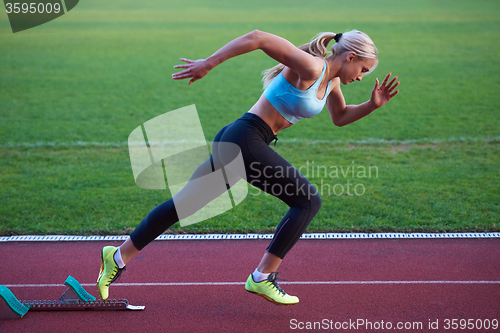 Image of pixelated design of woman  sprinter leaving starting blocks