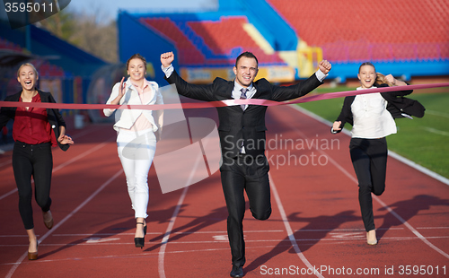 Image of business people running on racing track