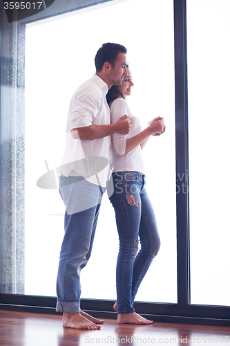 Image of relaxet young couple drink first morning coffee