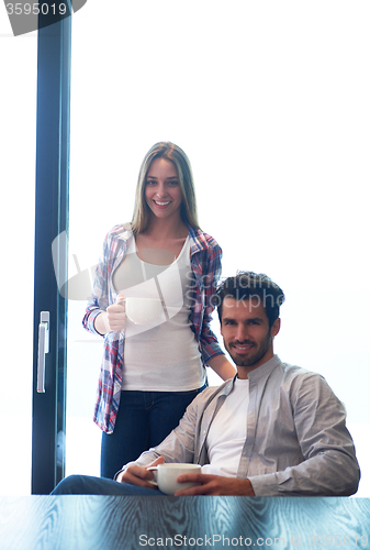 Image of relaxet young couple drink first morning coffee