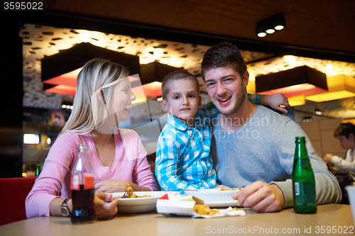 Image of family having lunch in shopping mall