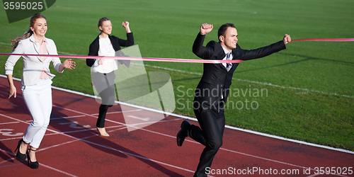 Image of business people running on racing track