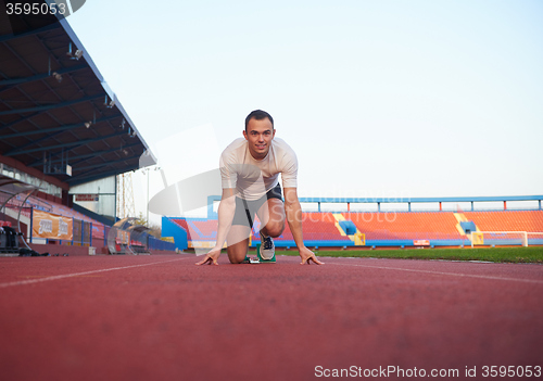 Image of pixelated design of woman  sprinter leaving starting blocks