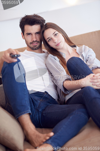 Image of young couple watching tv at home