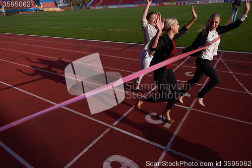 Image of business people running on racing track