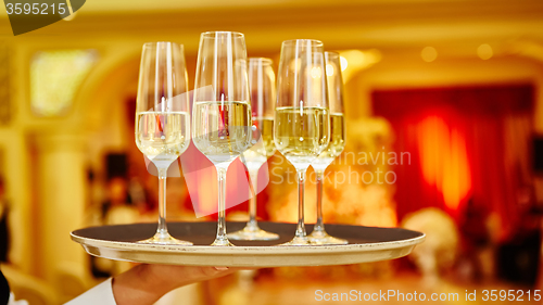 Image of Waiter serving champagne on a tray