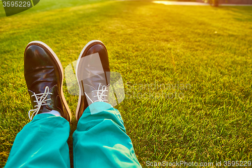 Image of Man relaxing, enjoying landscape on sunny day - point of view