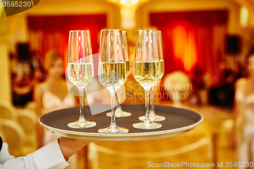 Image of Waiter serving champagne on a tray