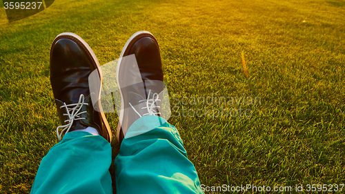 Image of Man relaxing, enjoying landscape on sunny day - point of view