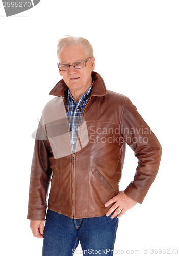 Image of Mature man in leather jacket standing.