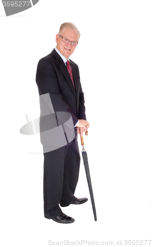 Image of Middle age man in suit with umbrella.