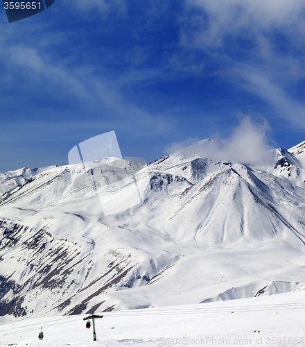 Image of Winter snowy mountains and ski slope at sun day